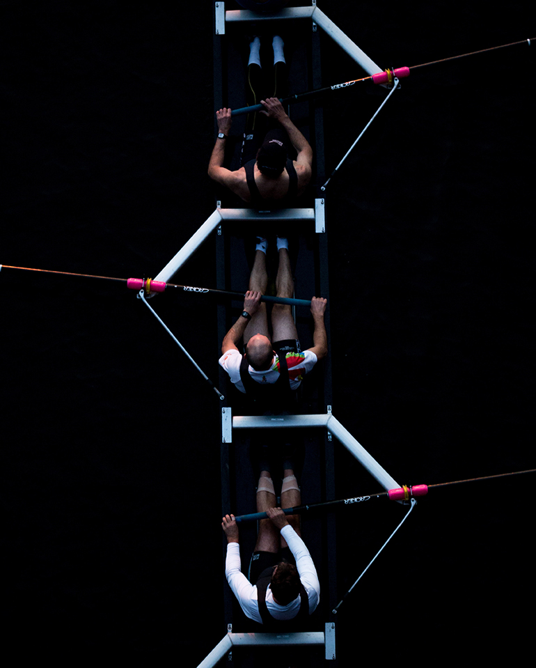 Rowers from above. Working as a team helps cut technical debt. Photo by Josh Calabrese on Unsplash. 