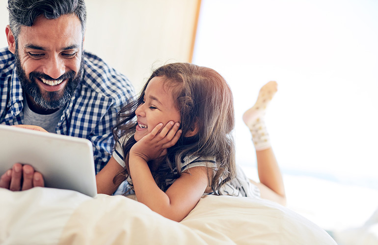 Father and daughter using a tablet.