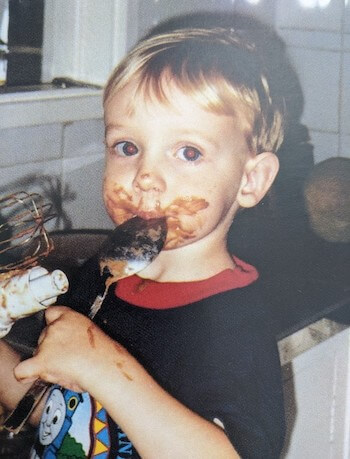 James E age 4 licking the baking spoon.