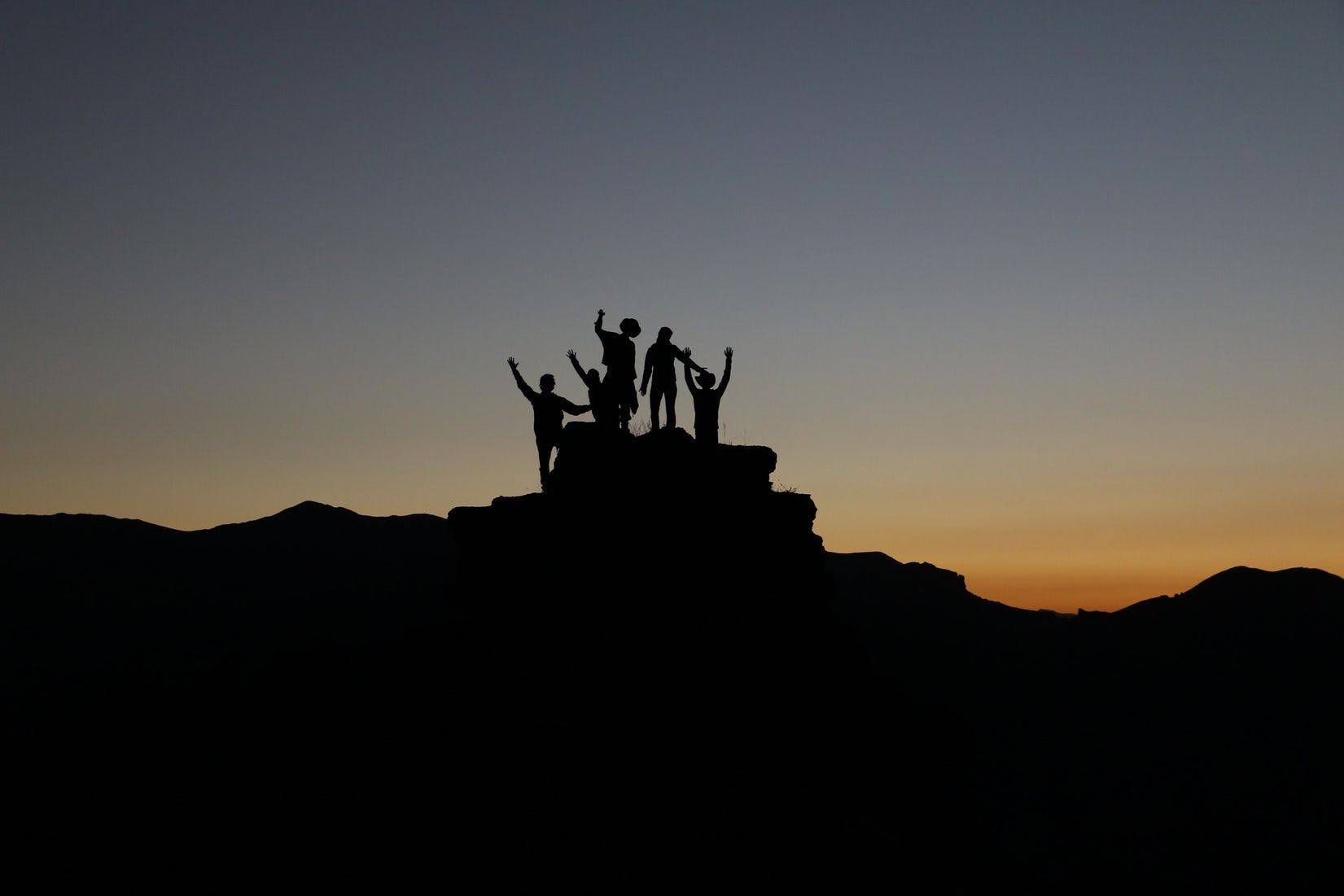 Celebrating reaching new heights. Team happiness photo by Natalie Pedigo on Unsplash.