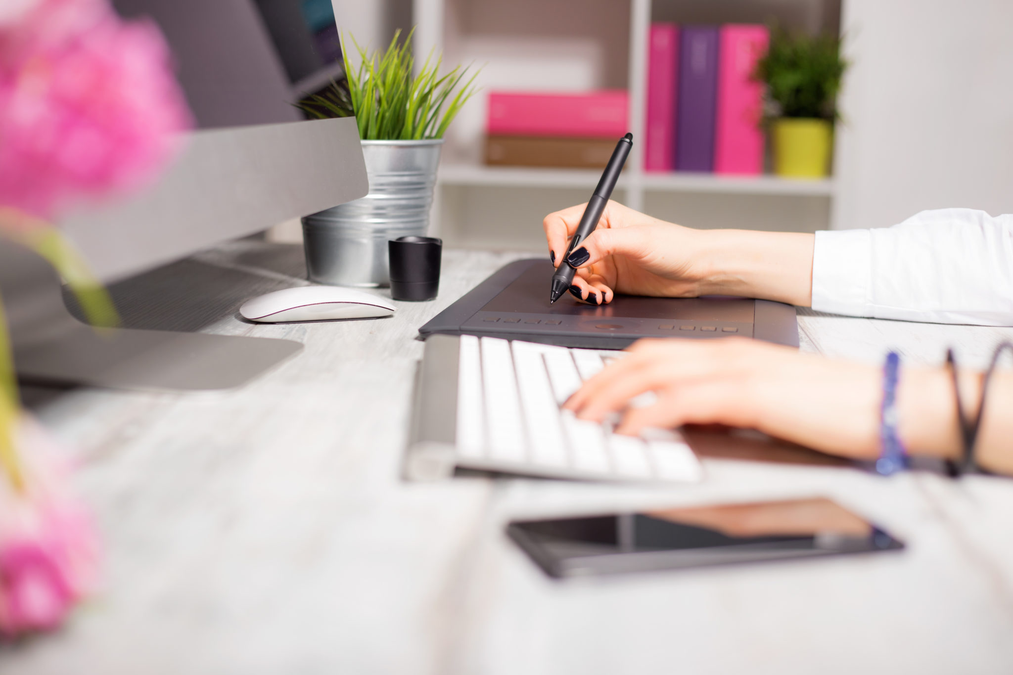 Designer's desk with computer and drawing pad. These UI design tips are for designers and their clients.