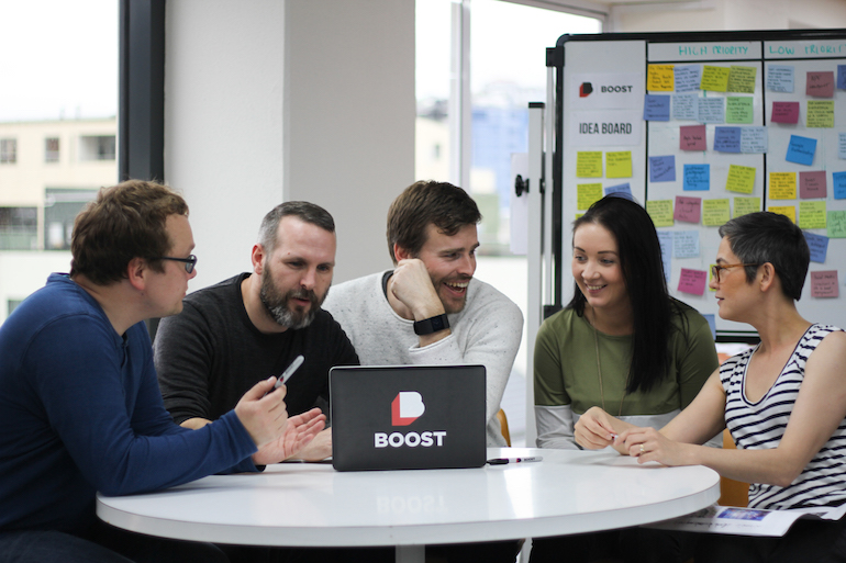 A team discusses user stories. The best user story examples are created collaboratively.